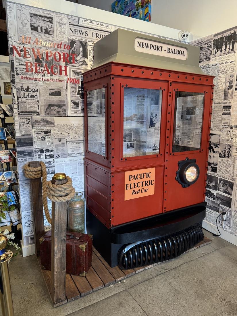 Streetcar prop seen from an angle with rope posts, a suitcase and a vintage fire extinguisher